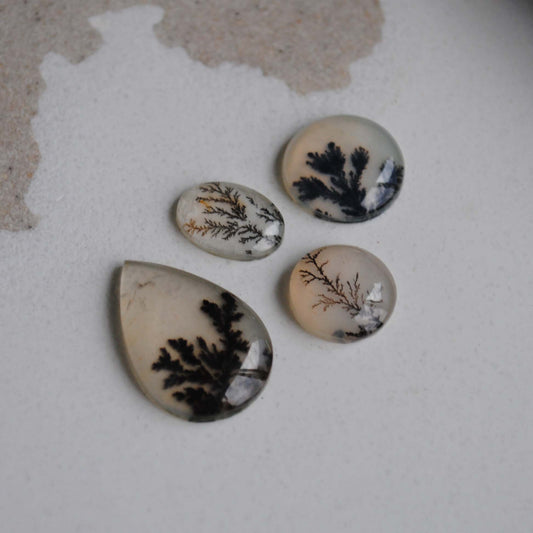 Dendritic agate stones on a light background