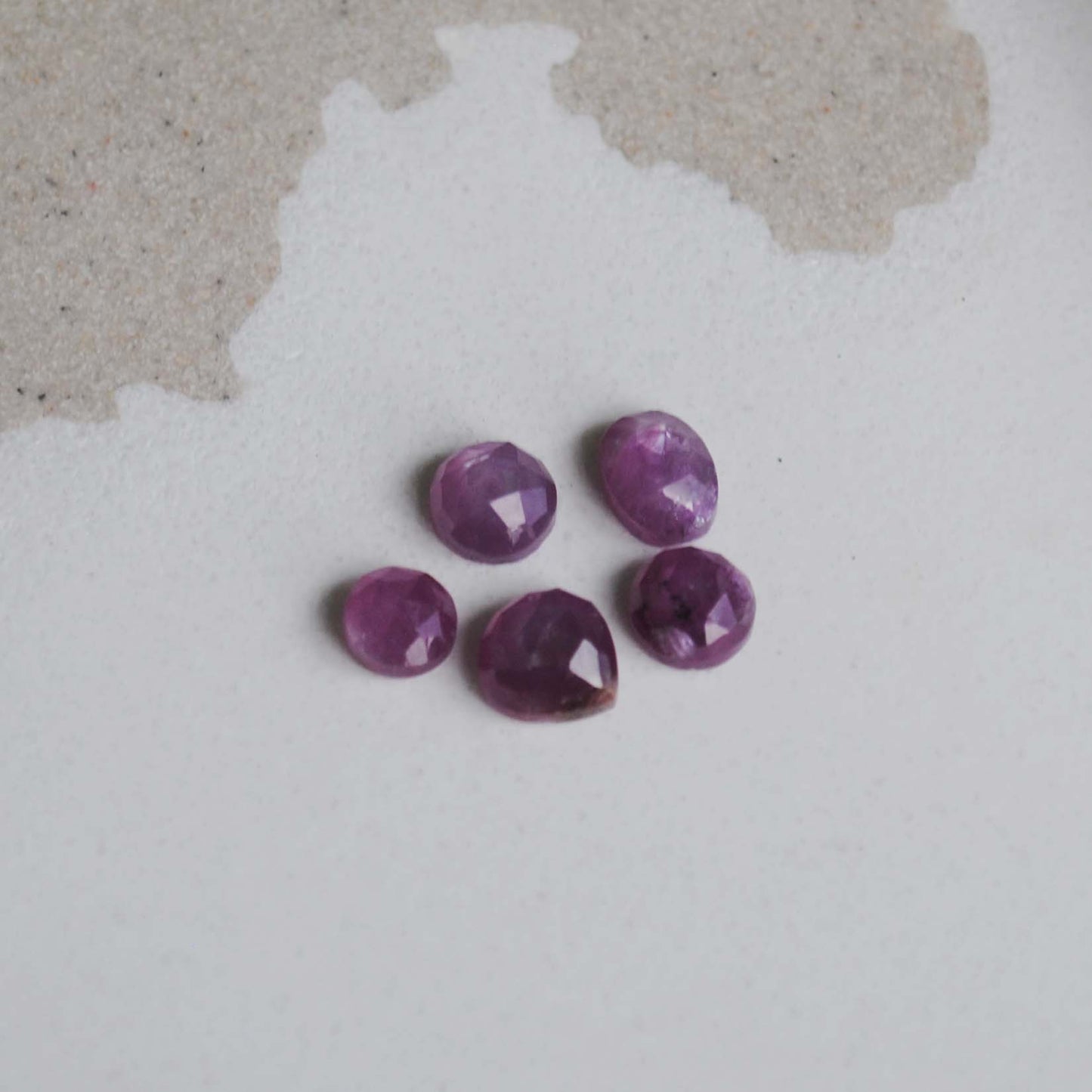 Rose cut sapphires on light background
