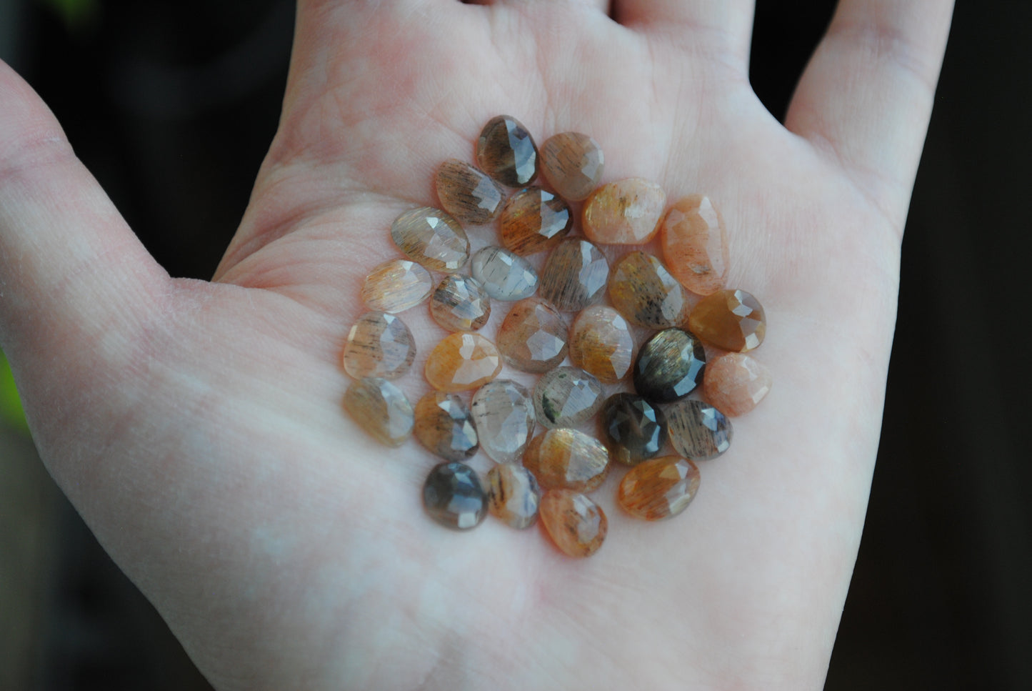 Golden sheen moonstone rose cut cabochons on palm of hand