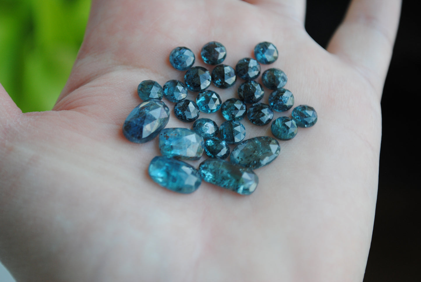 Kyanite rose cut cabochons on palm of hand