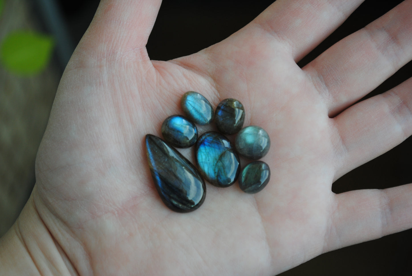Labradorite cabochons on palm of hand