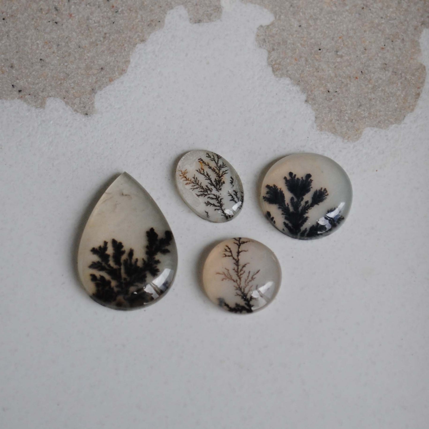 Dendritic agate stones on a light background