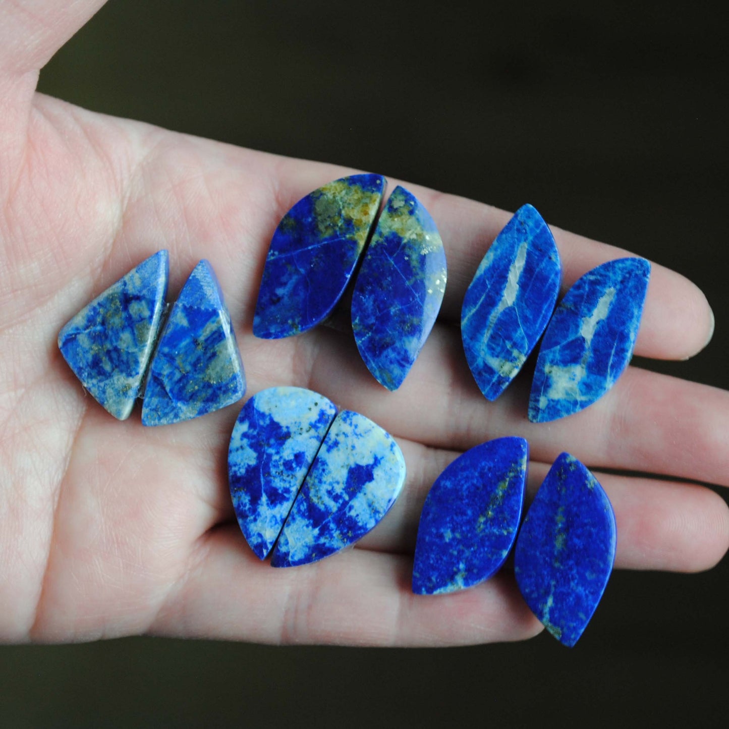 Lapis lazuli pair cabochons held in palm of hand