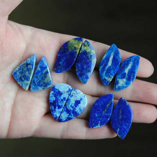 Lapis lazuli pair cabochons held in palm of hand