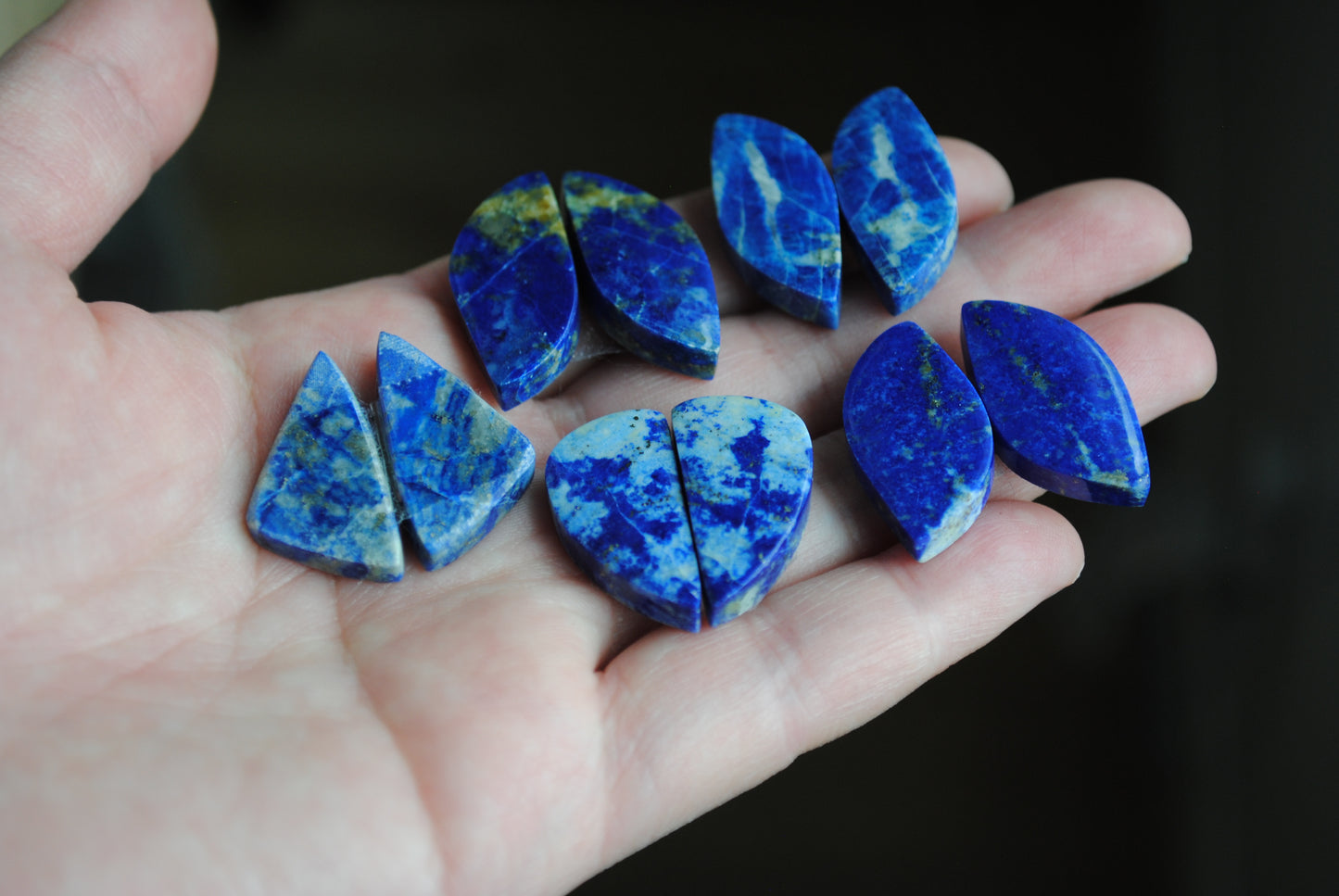 Lapis lazuli pair cabochons held in palm of hand