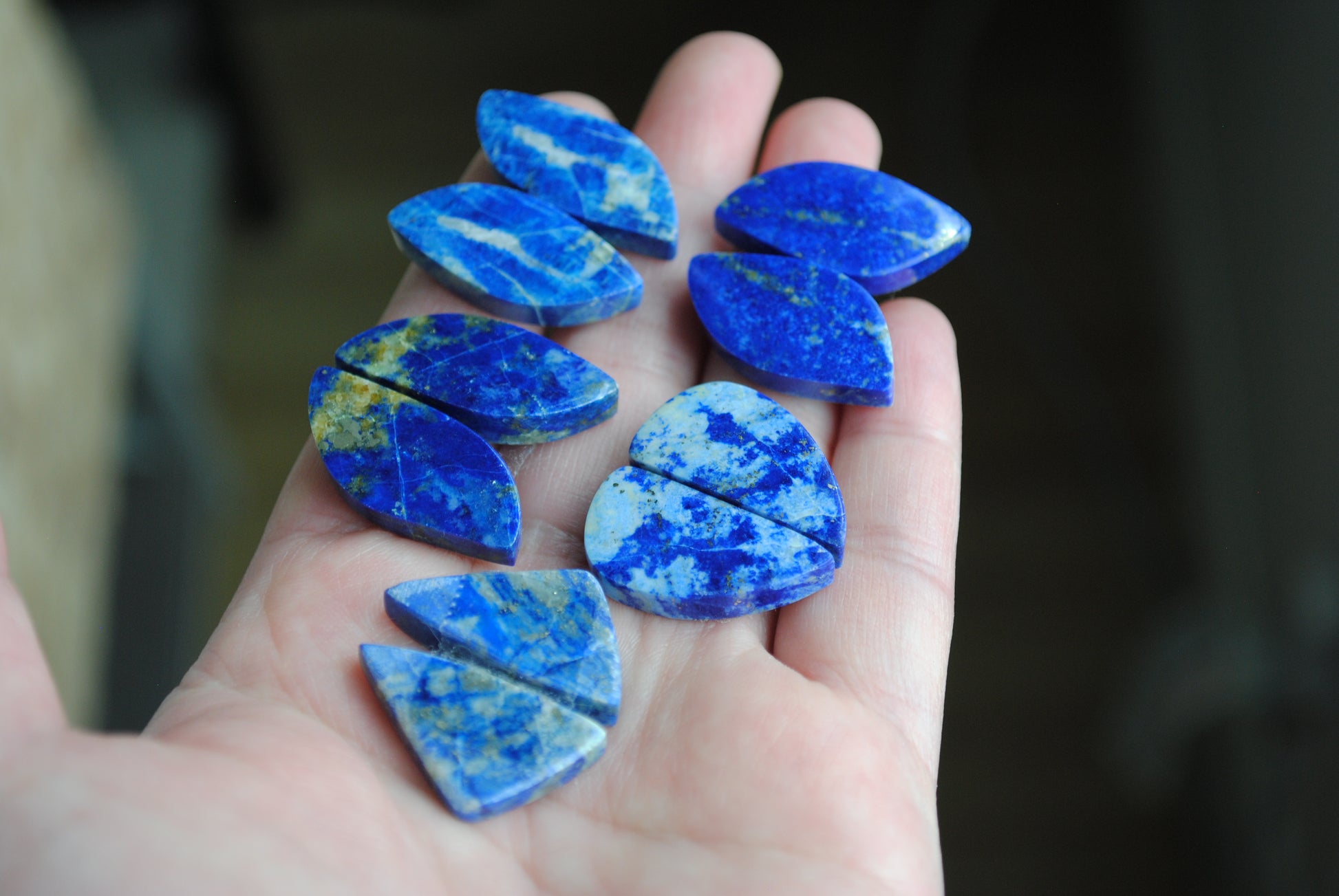 Lapis lazuli pair cabochons held in palm of hand