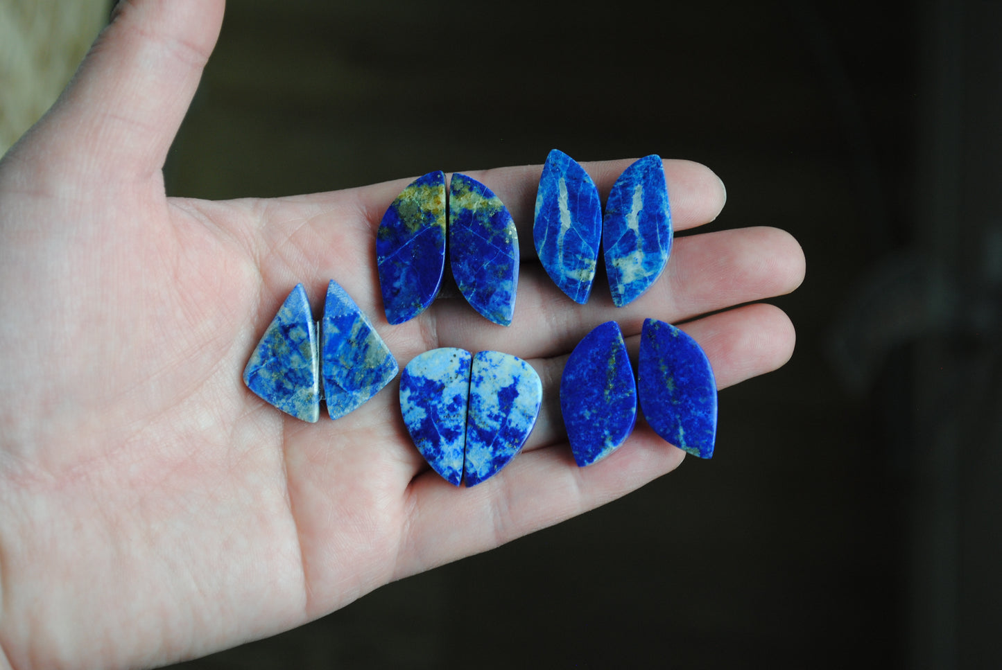 Lapis lazuli pair cabochons held in palm of hand