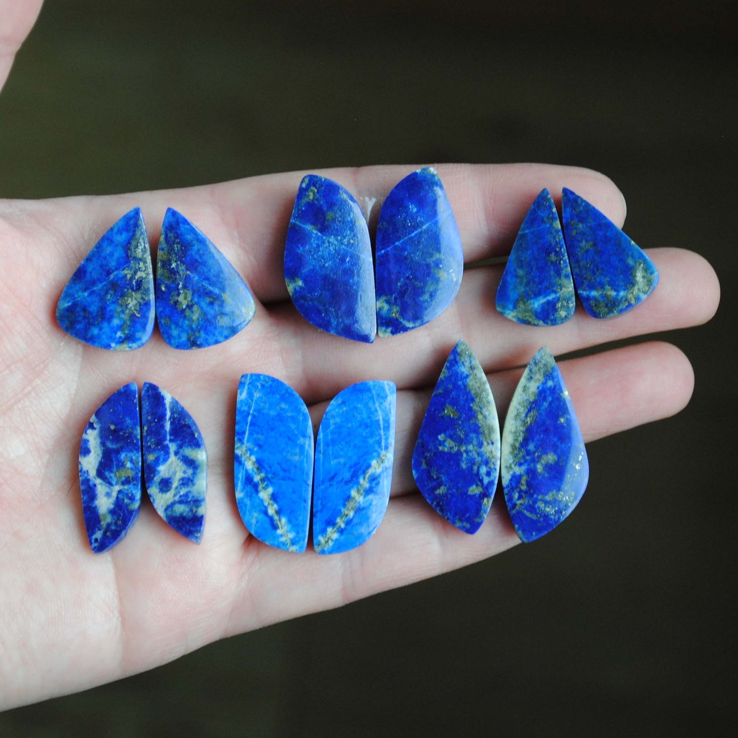 Lapis lazuli pair cabochons held in palm of hand