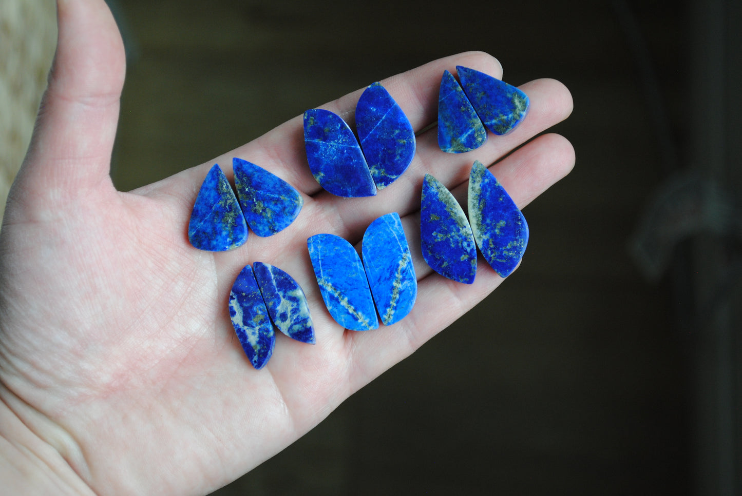 Lapis lazuli pair cabochons held in palm of hand