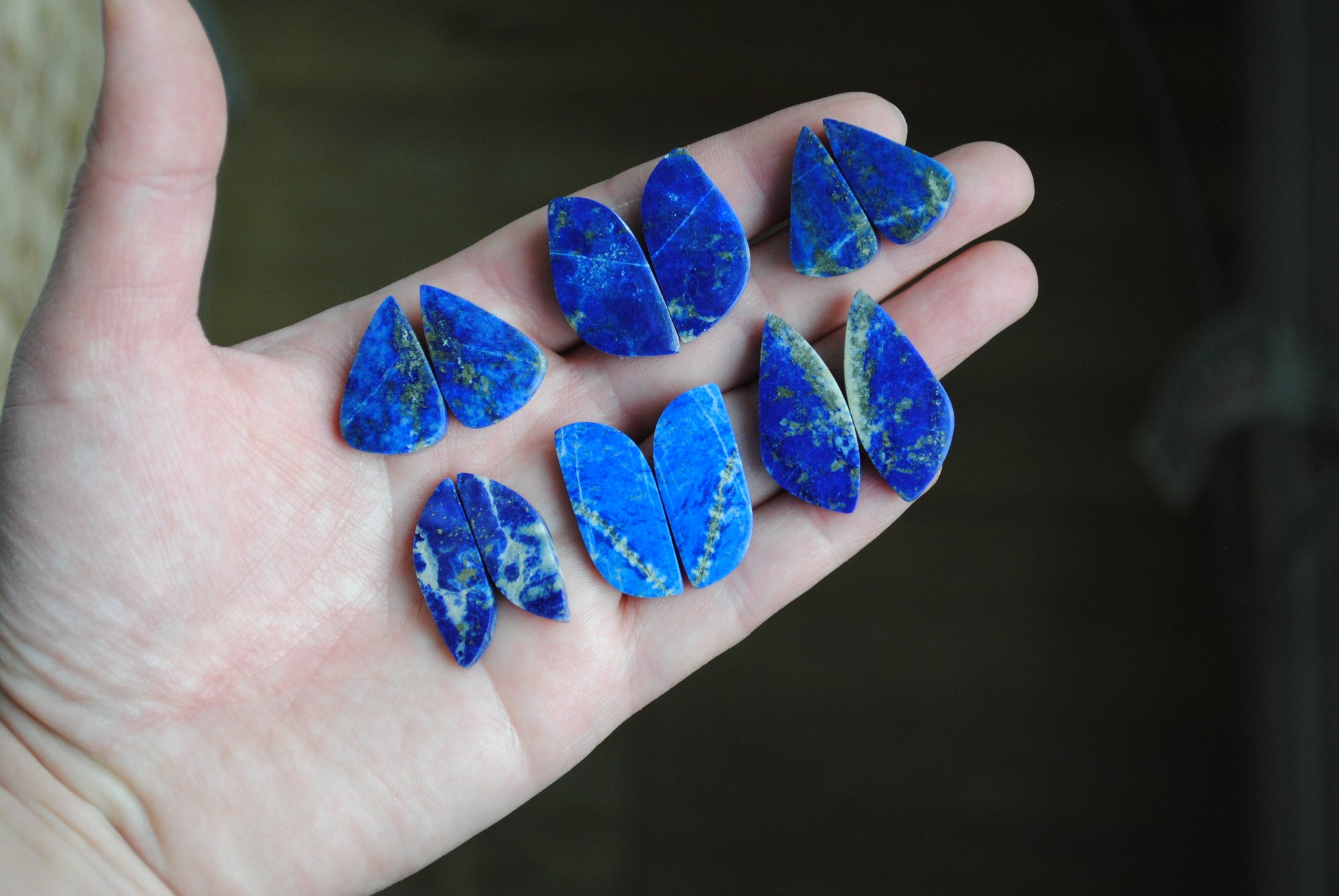 Lapis lazuli pair cabochons held in palm of hand