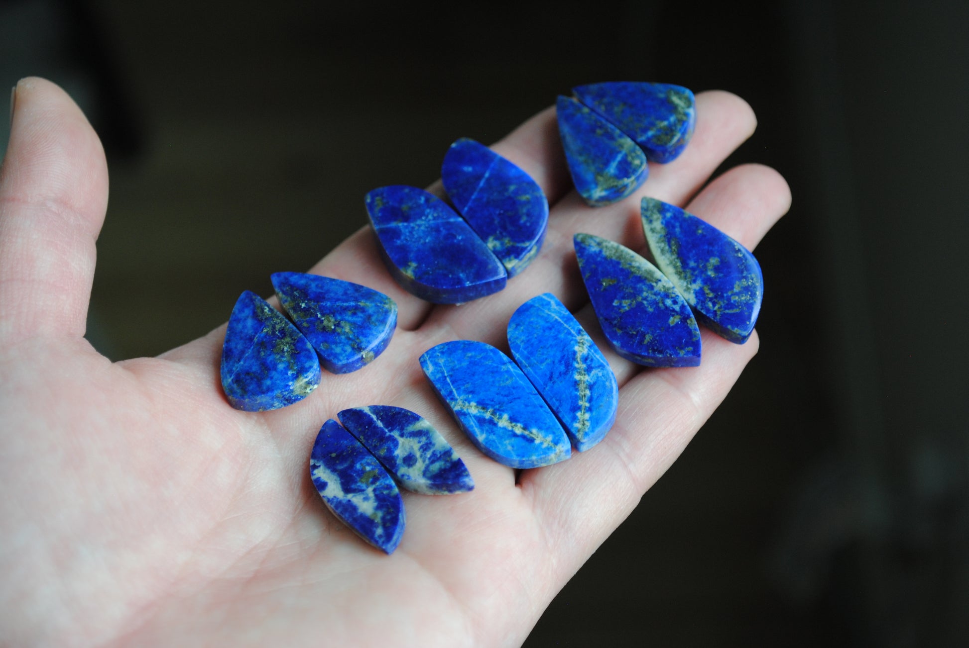 Lapis lazuli pair cabochons held in palm of hand