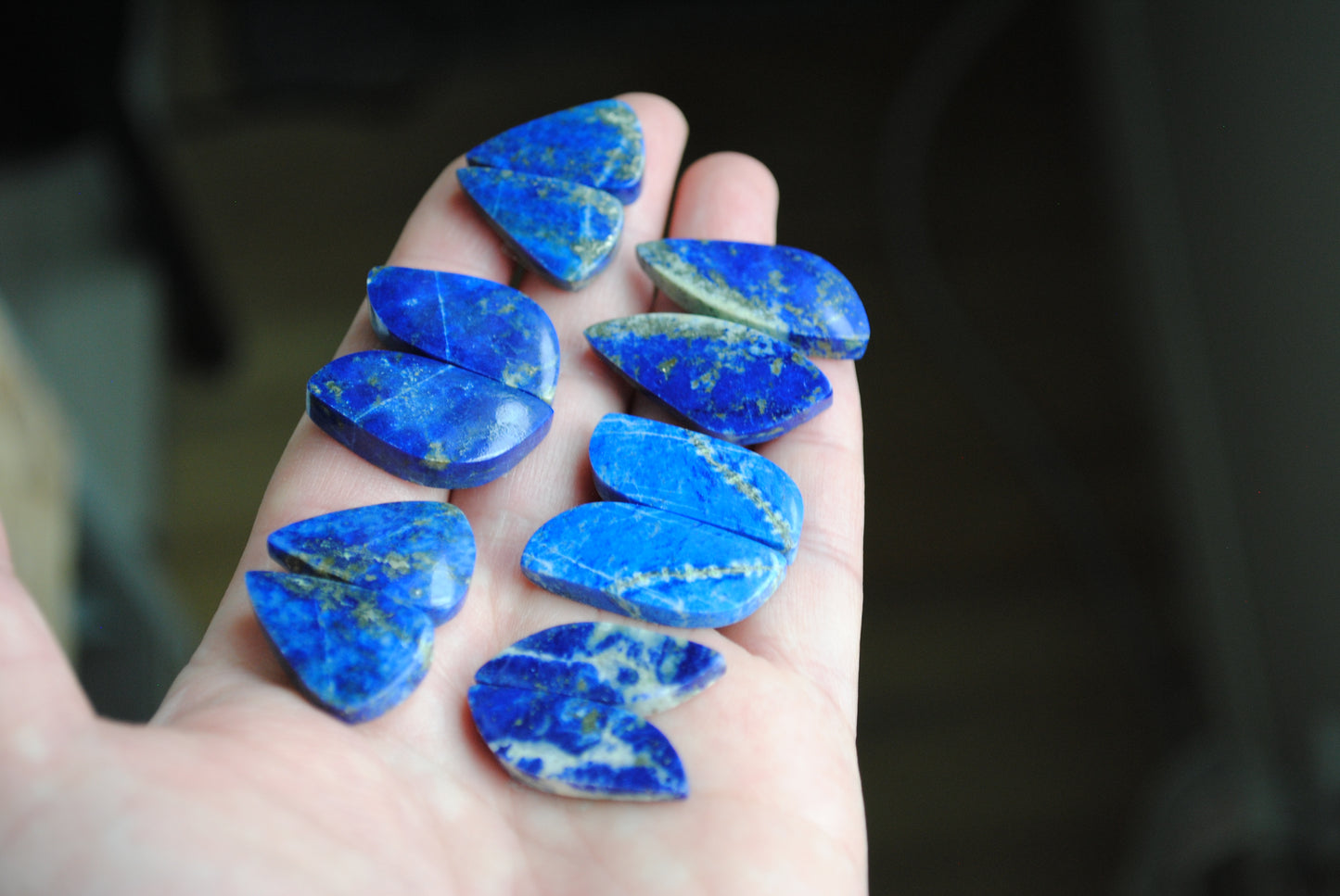 Lapis lazuli pair cabochons held in palm of hand