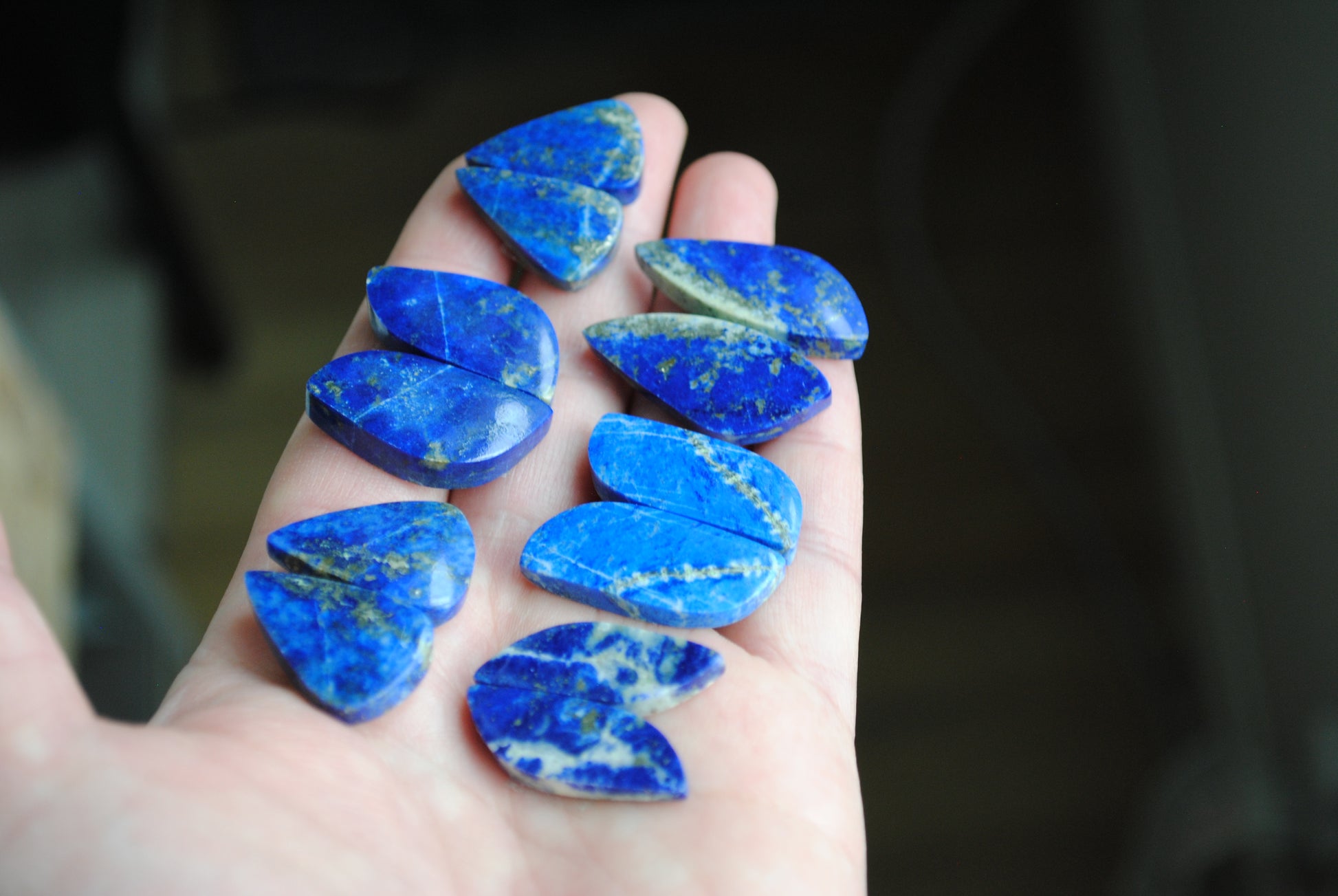 Lapis lazuli pair cabochons held in palm of hand