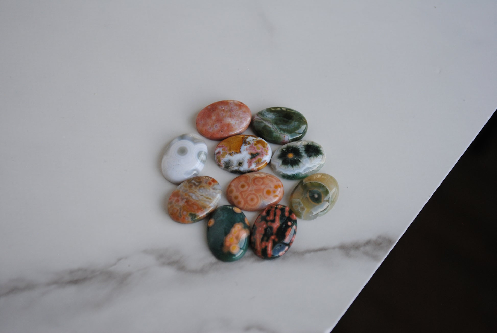 Collection of multicolored stones on a marble surface
