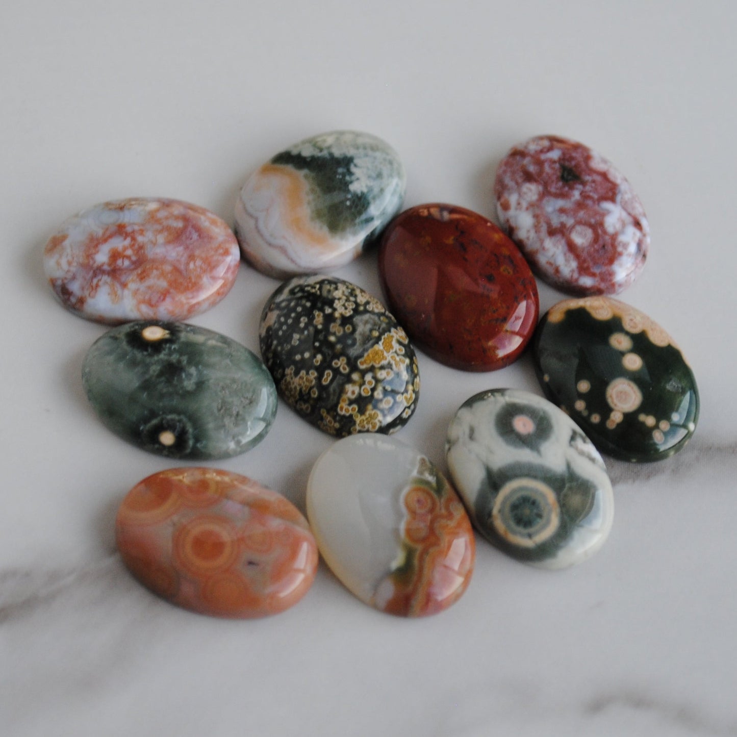 Assorted colorful stones on a marble surface