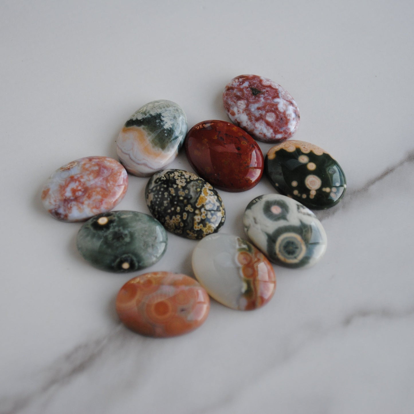 Collection of marbled stones on a marble surface