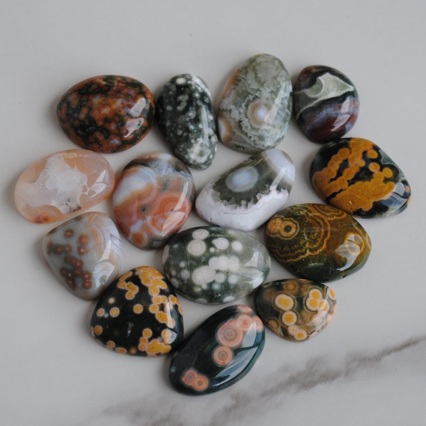 Collection of painted pebbles on a marble surface