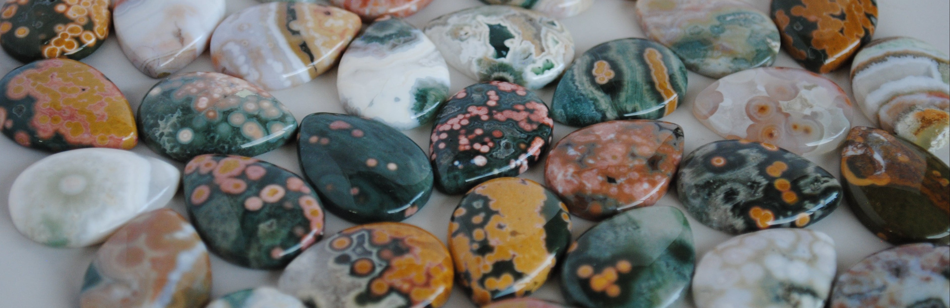 Collection of multicolored agate stones with various patterns.