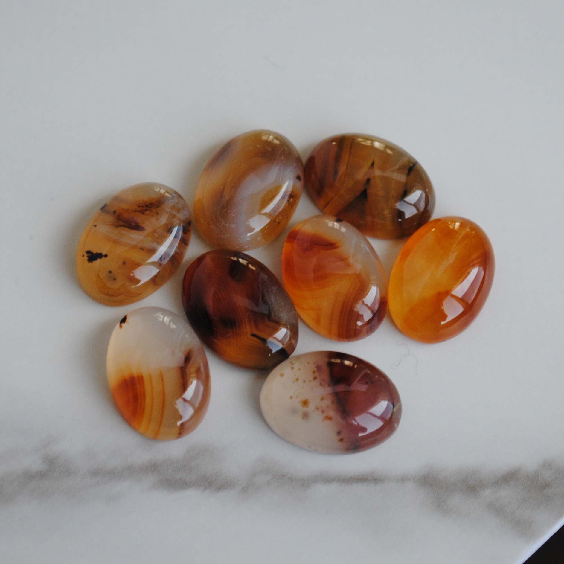 Montana agate cabochons on light background