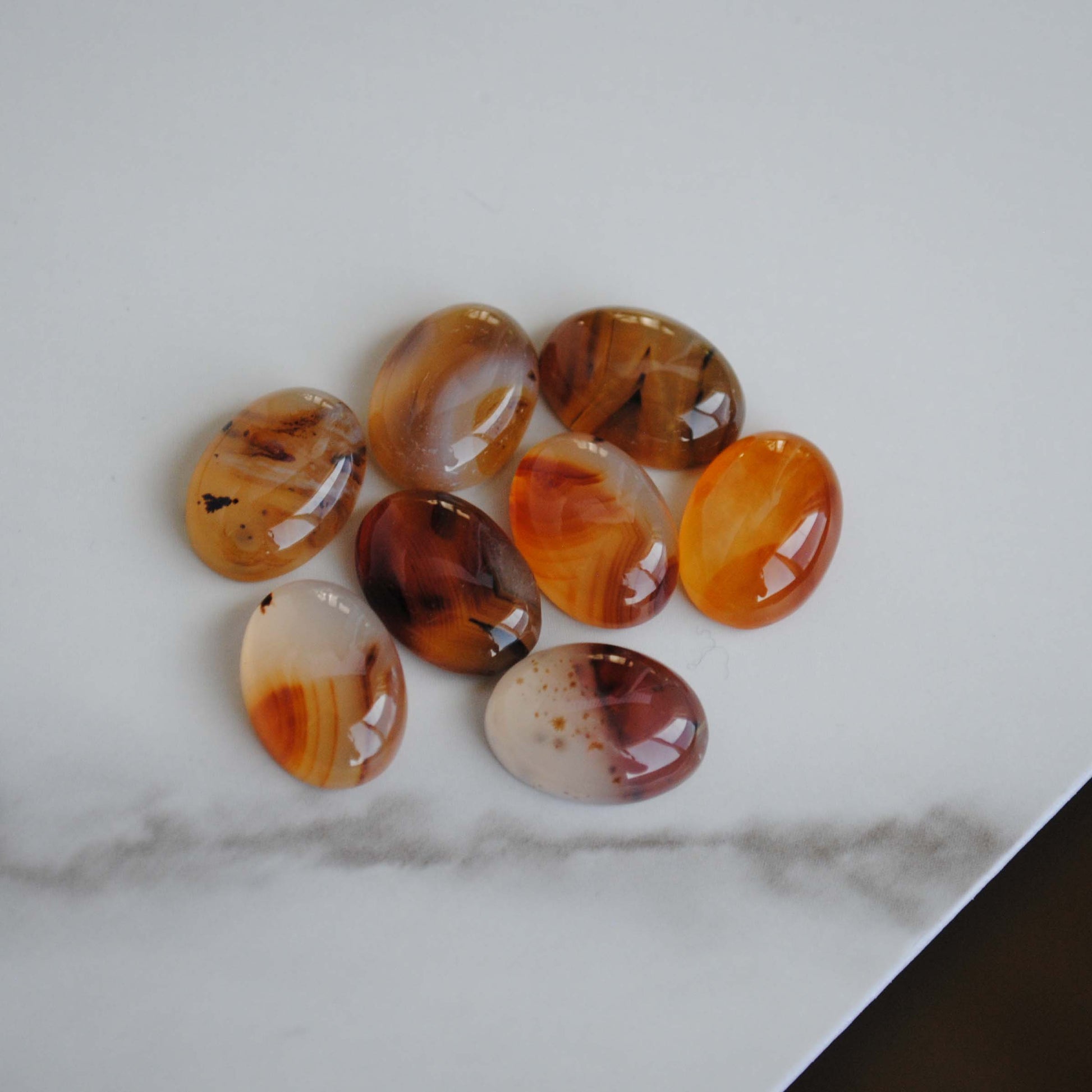 Montana agate cabochons on light background