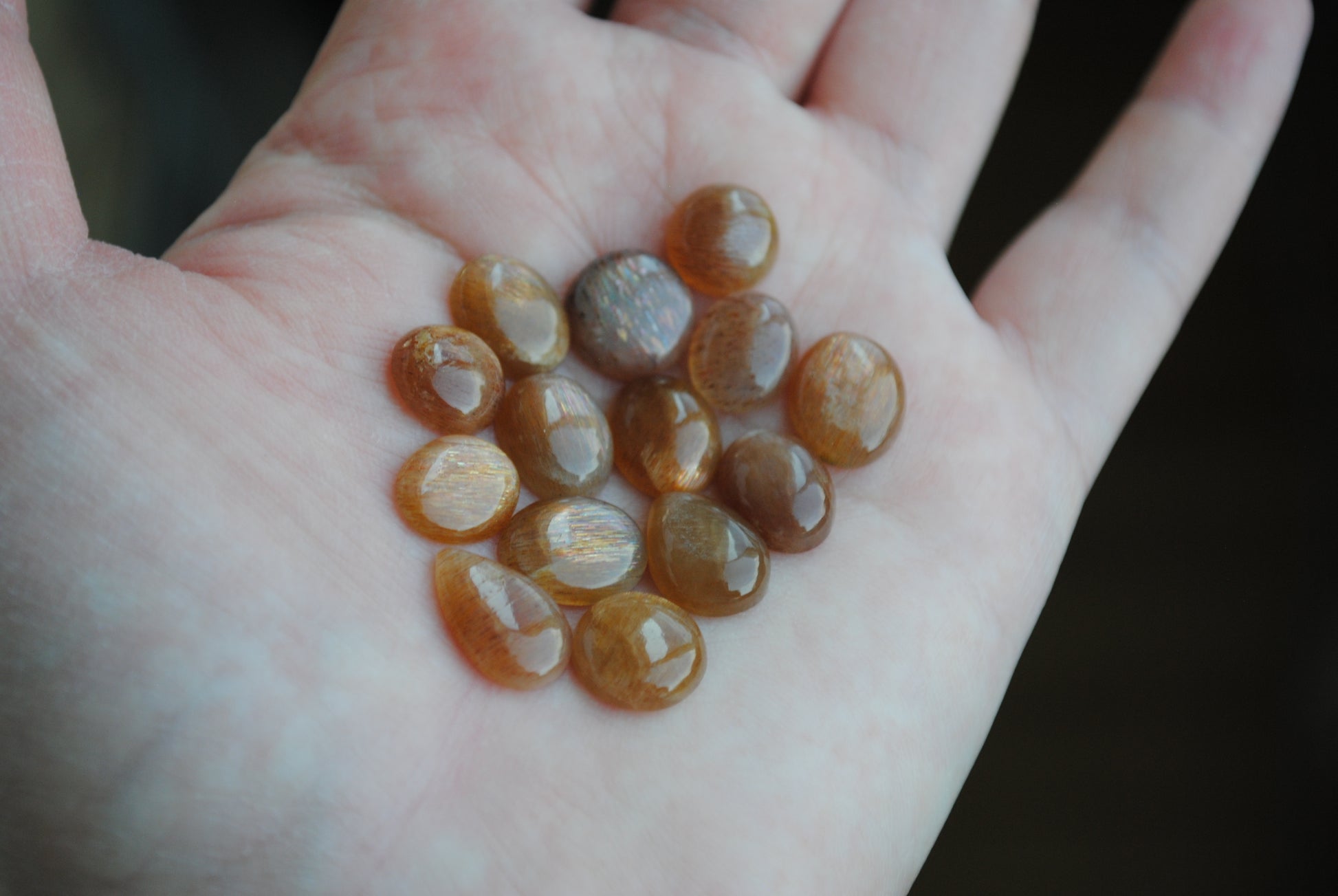 Golden sheen moonstone cabochons on light background