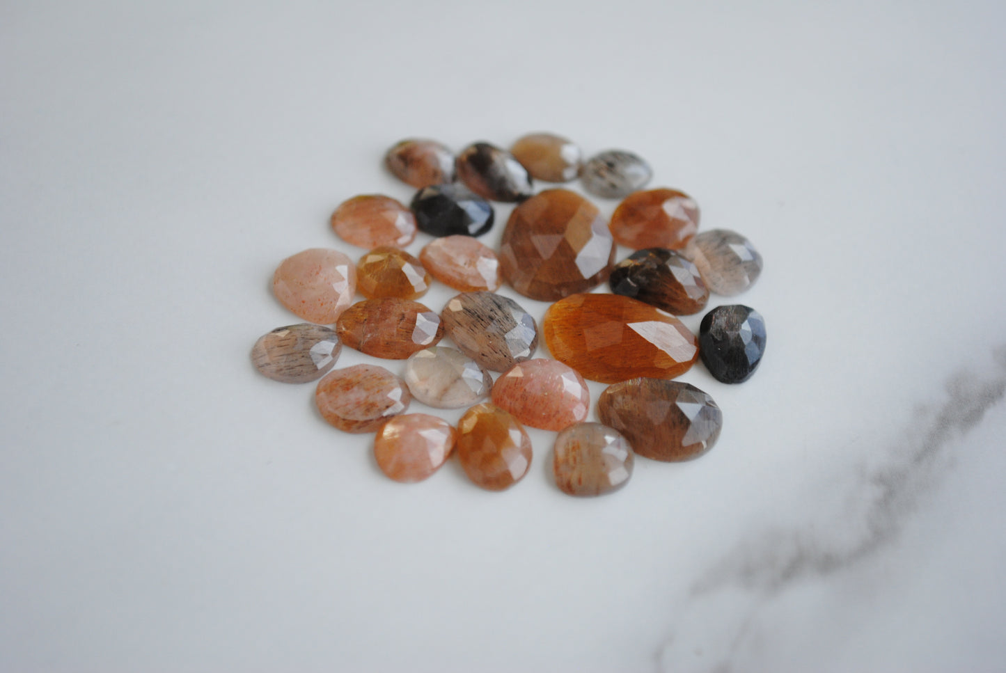 Golden sheen moonstone rose cut cabochons on light background