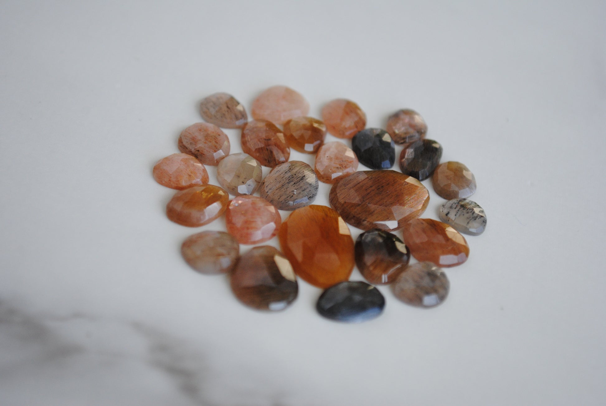 Golden sheen moonstone rose cut cabochons on light background