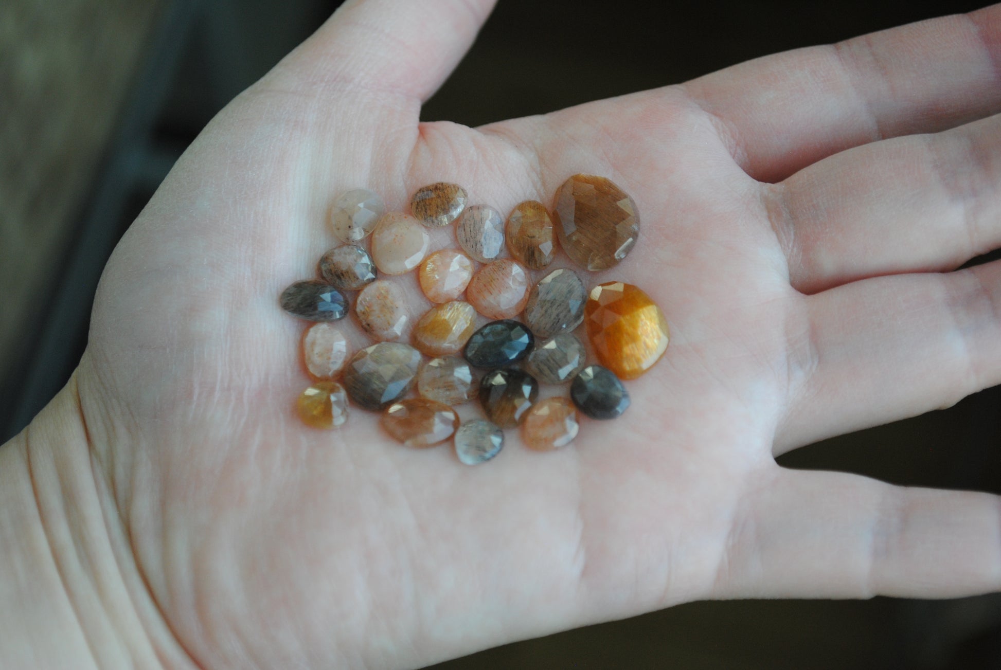 Golden sheen moonstone rose cut cabochons on palm of hand