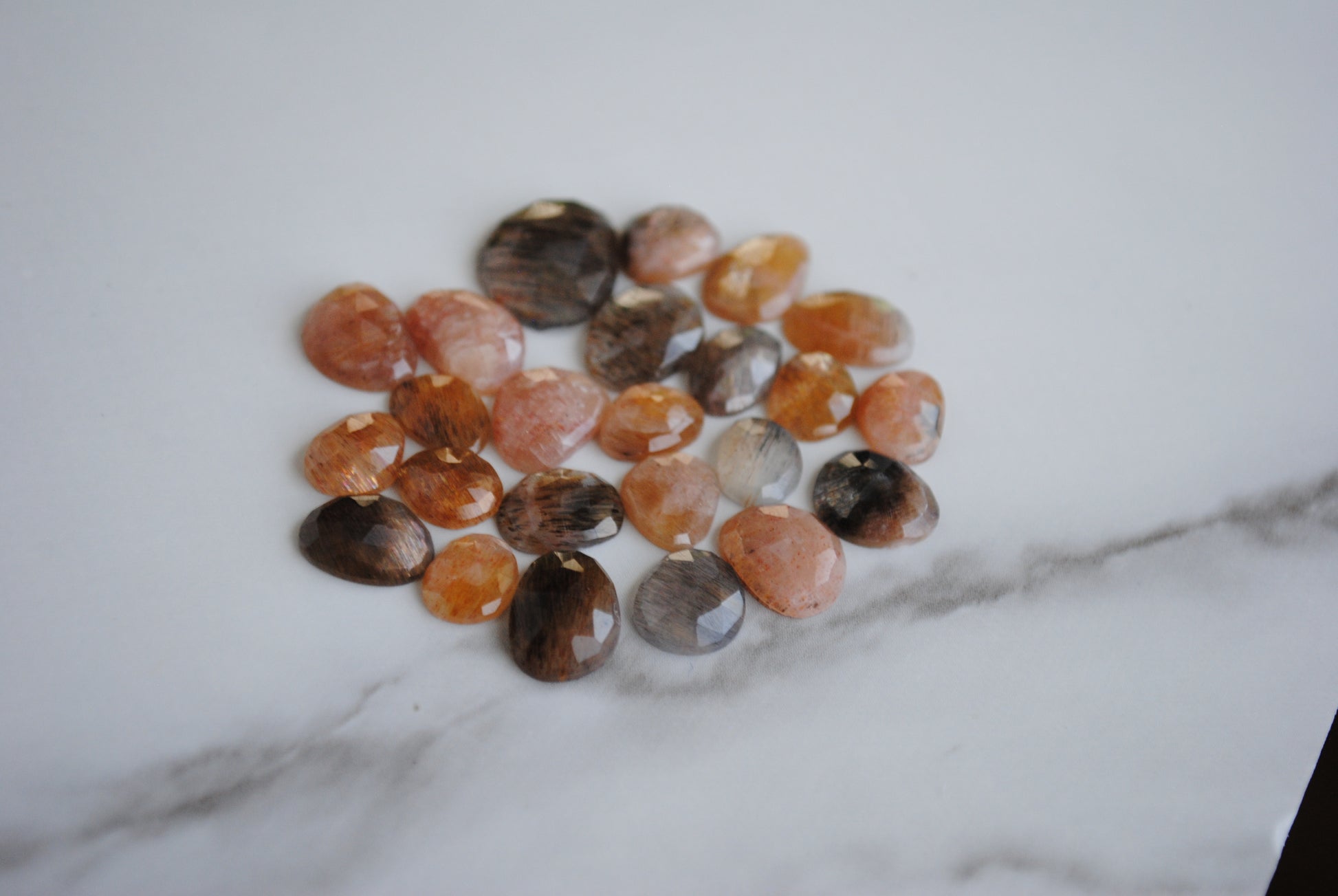 Golden sheen moonstone rose cut cabochons on light background