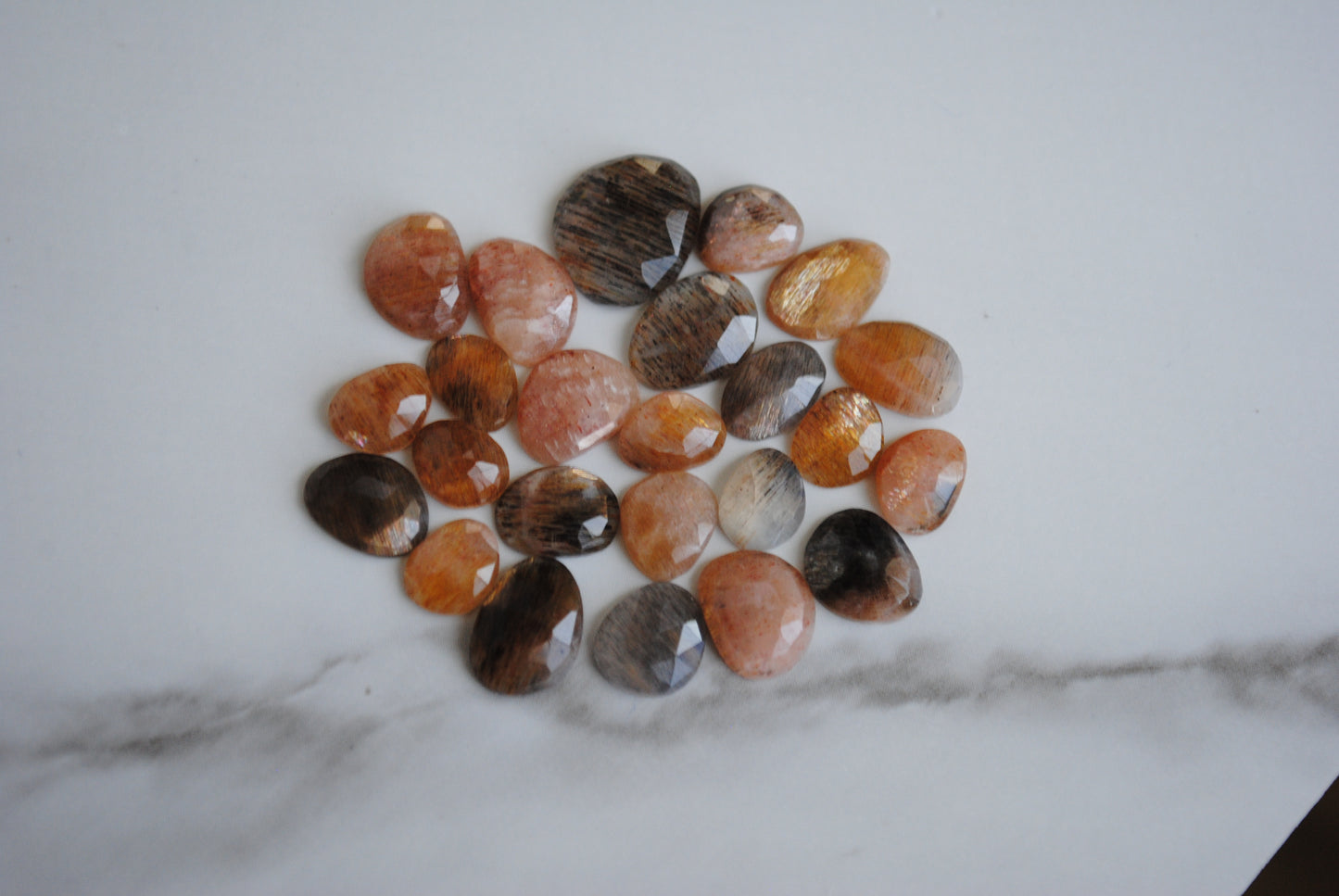 Golden sheen moonstone rose cut cabochons on light background