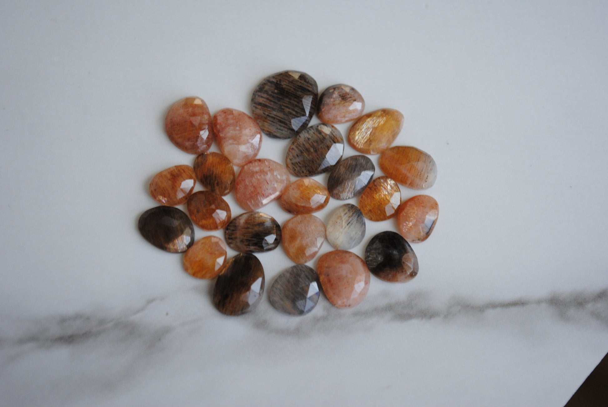 Golden sheen moonstone rose cut cabochons on light background