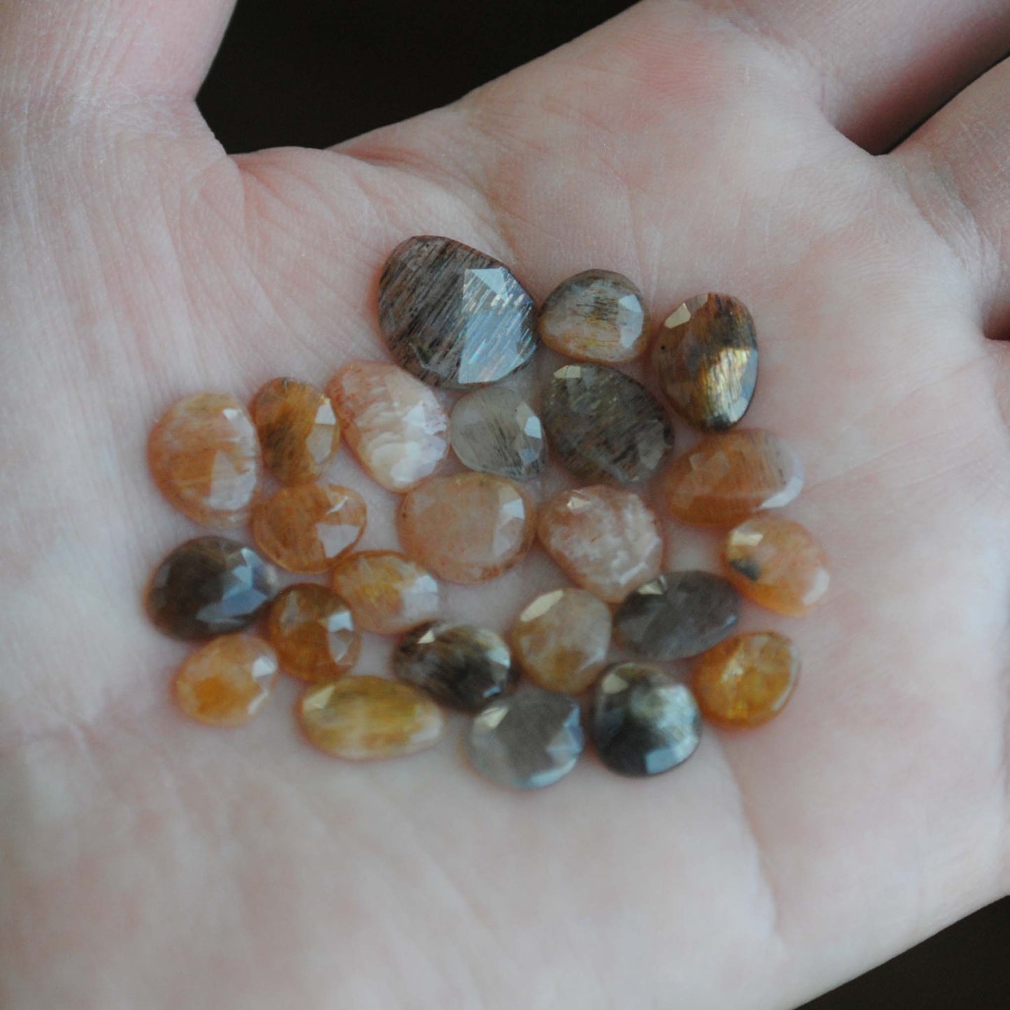 Golden sheen moonstone rose cut cabochons on palm of hand