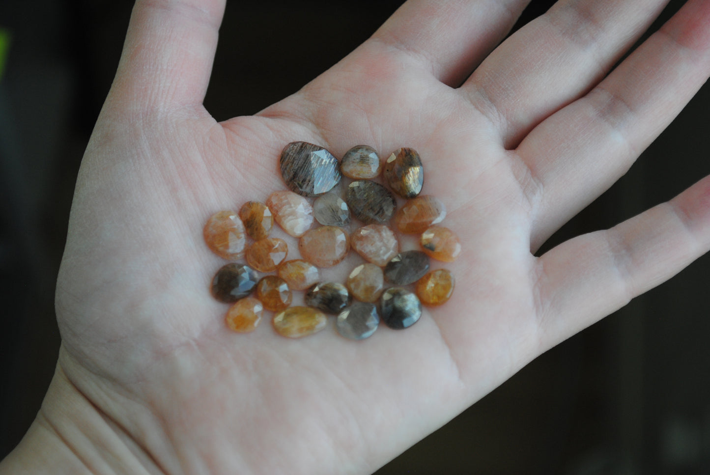 Golden sheen moonstone rose cut cabochons on palm of hand