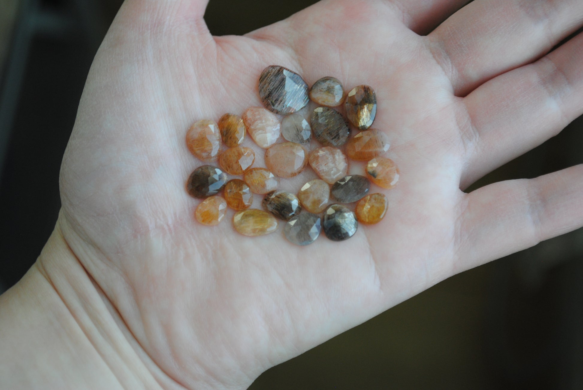 Golden sheen moonstone rose cut cabochons on palm of hand