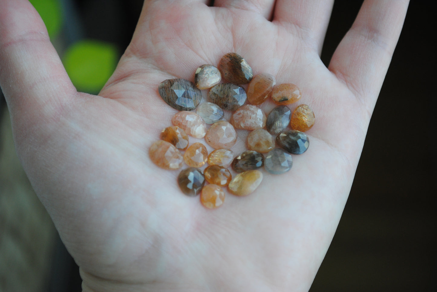 Golden sheen moonstone rose cut cabochons on palm of hand