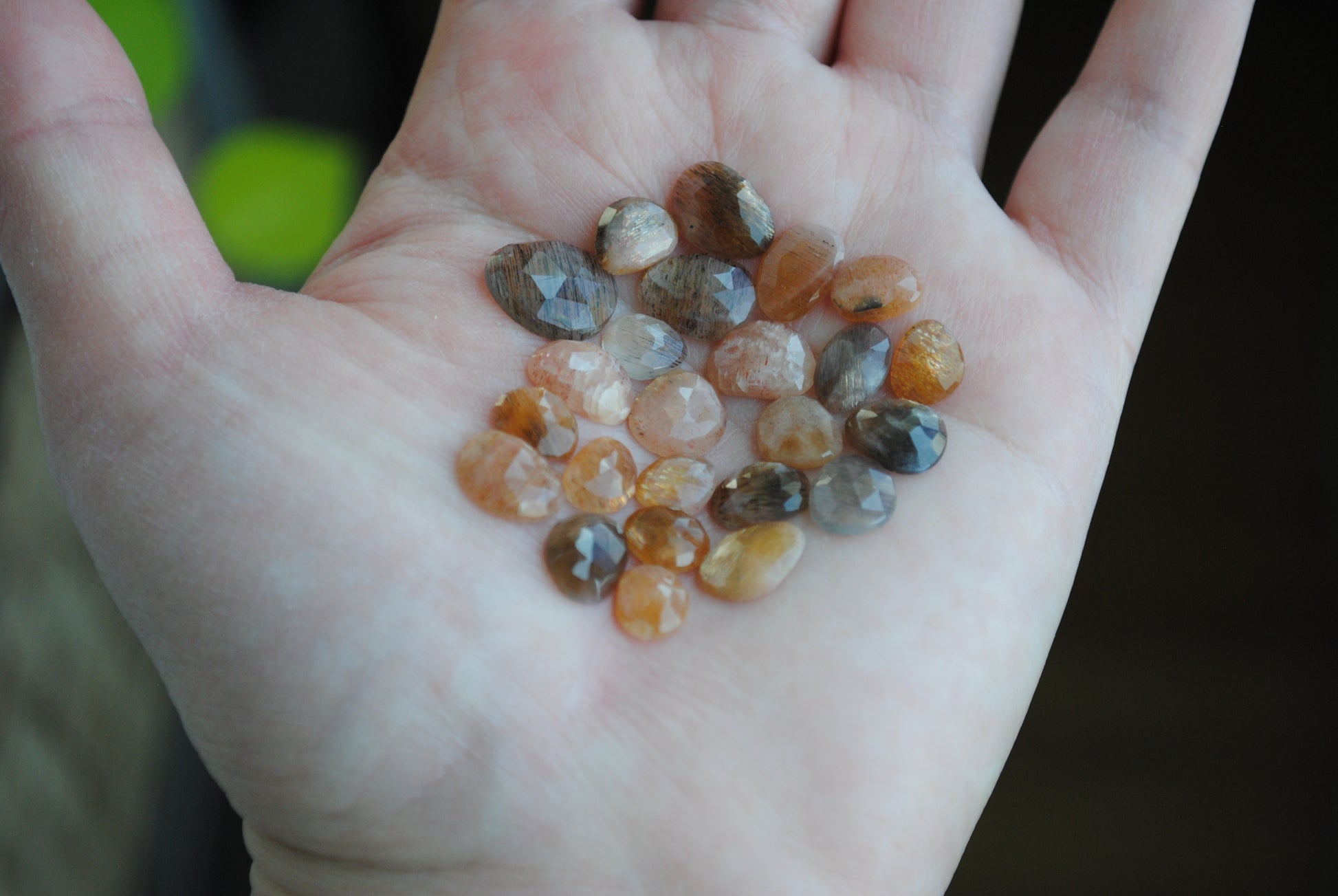 Golden sheen moonstone rose cut cabochons on palm of hand