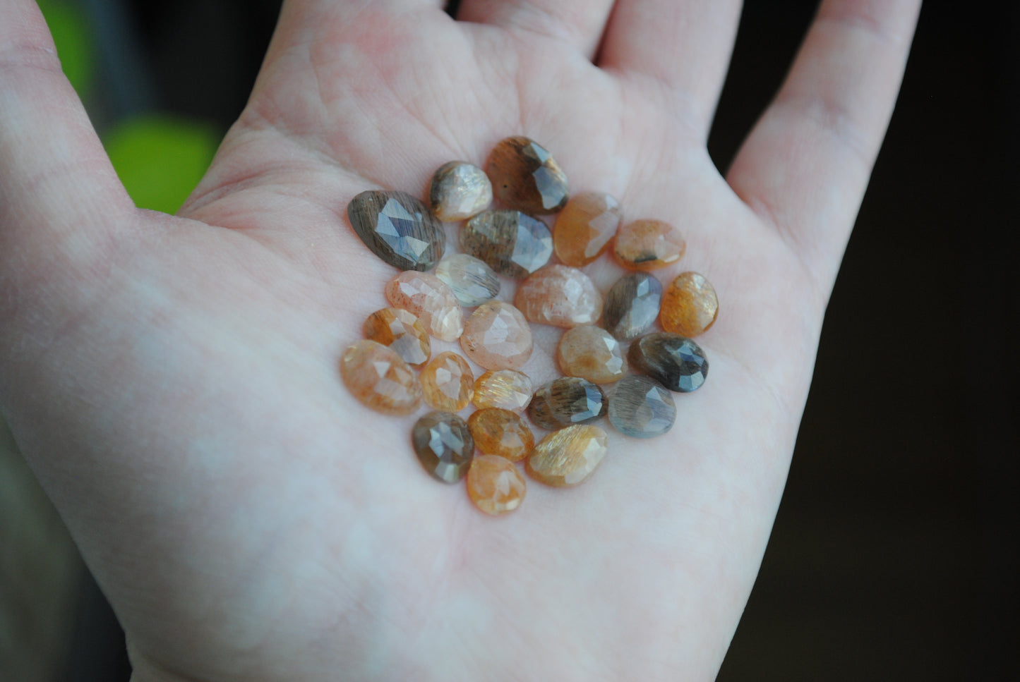 Golden sheen moonstone rose cut cabochons on palm of hand