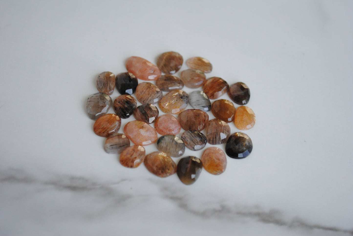 Golden sheen moonstone rose cut cabochons on light background