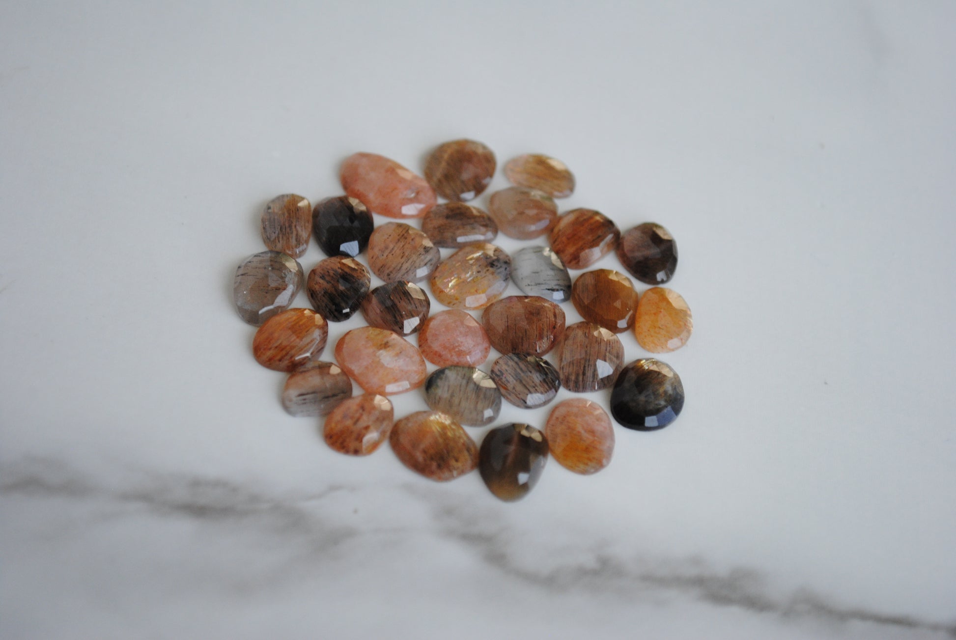 Golden sheen moonstone rose cut cabochons on light background