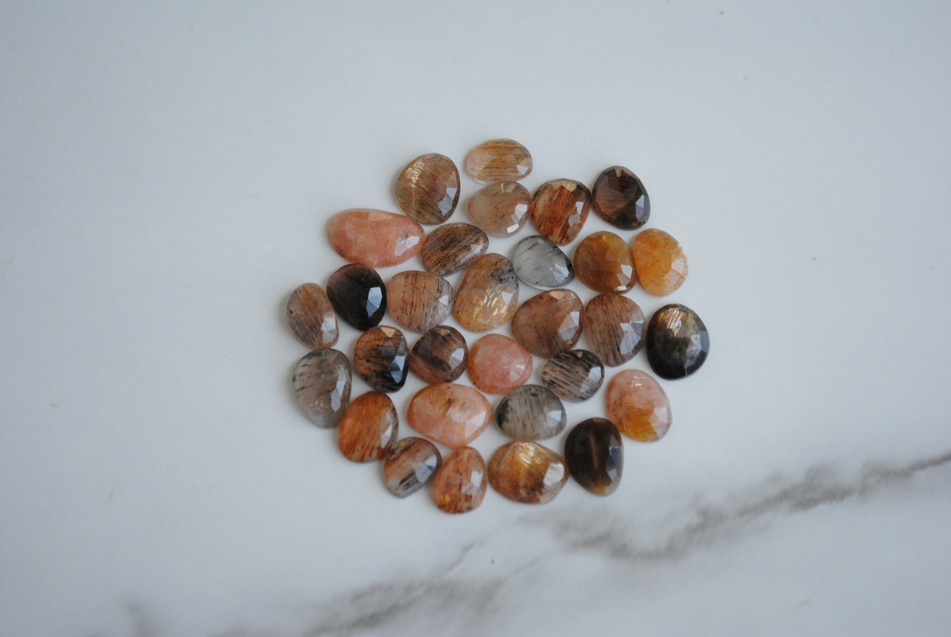 Golden sheen moonstone rose cut cabochons on light background