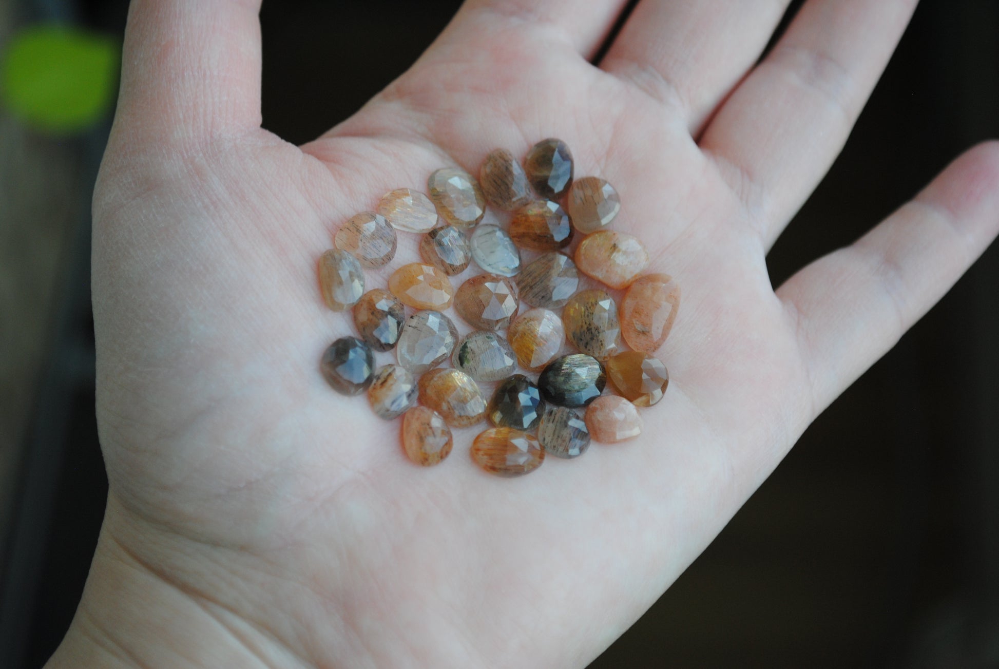 Golden sheen moonstone rose cut cabochons on palm of hand