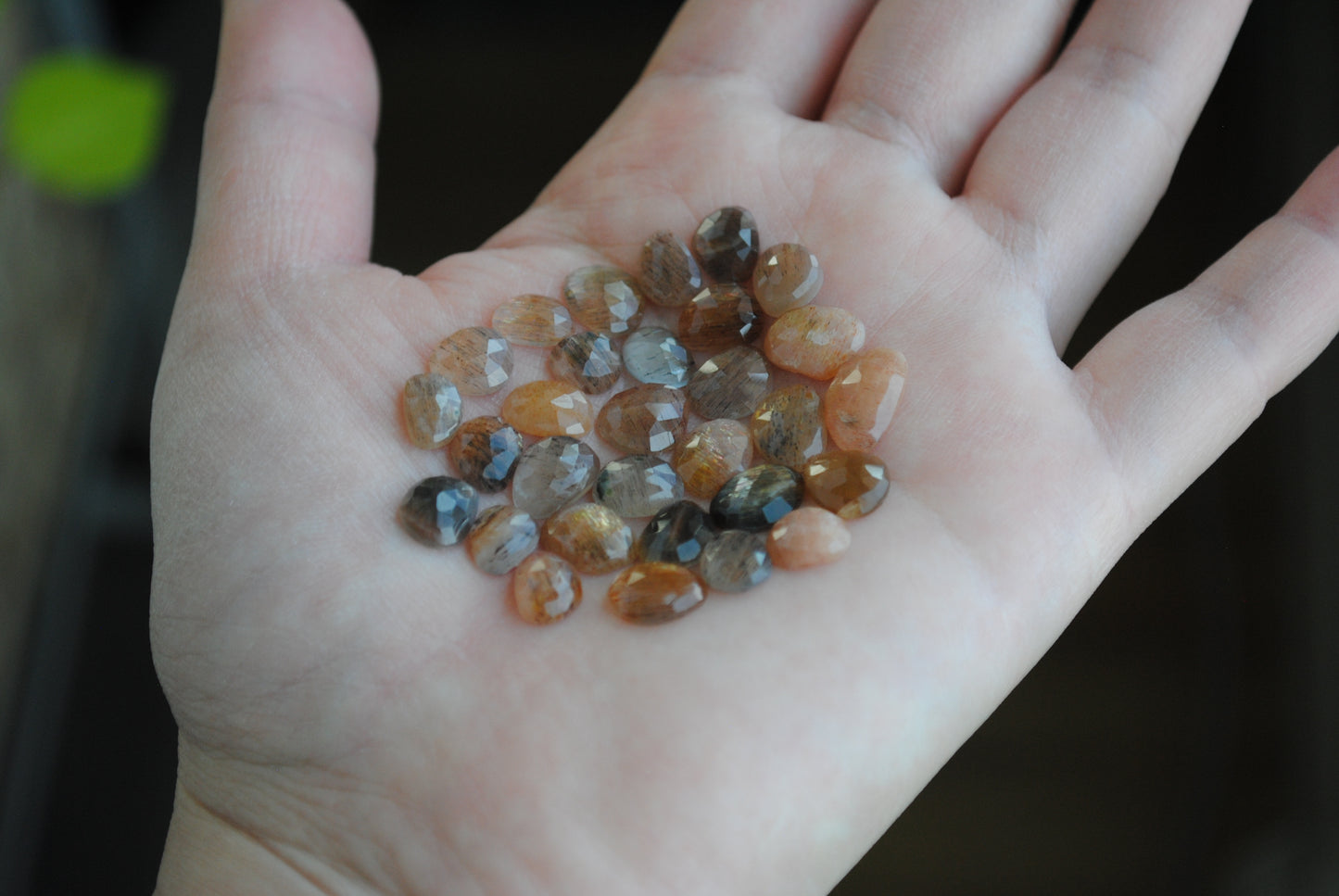 Golden sheen moonstone rose cut cabochons on palm of hand