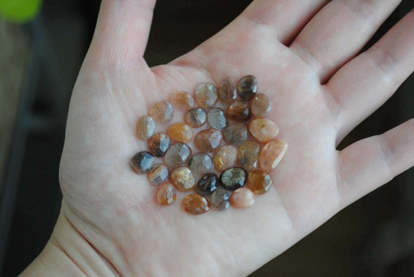 Golden sheen moonstone rose cut cabochons on palm of hand