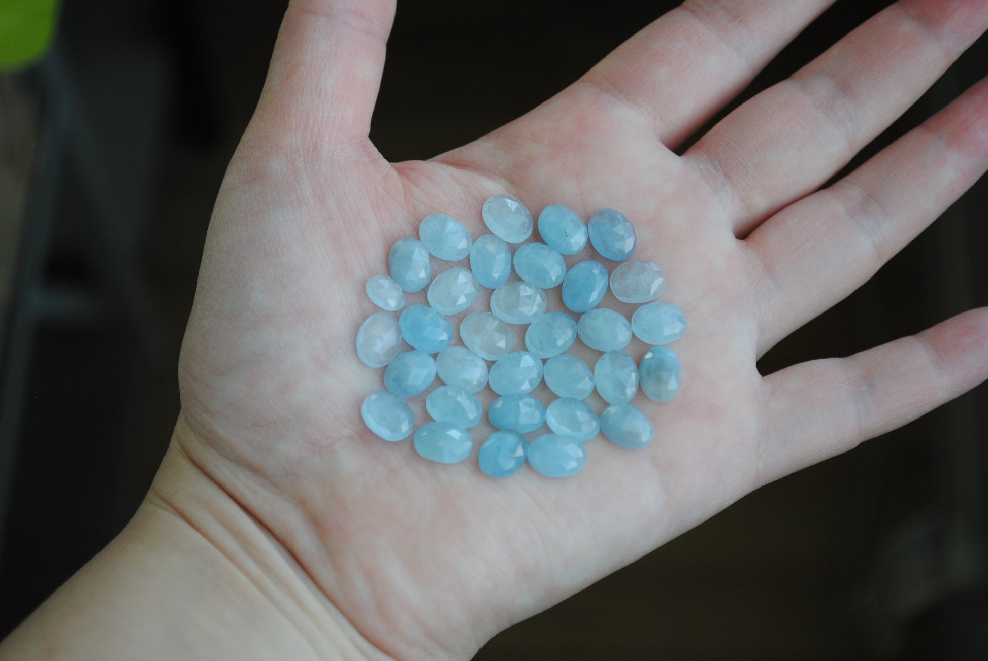 Aquamarine rose cut cabochons on palm of hand