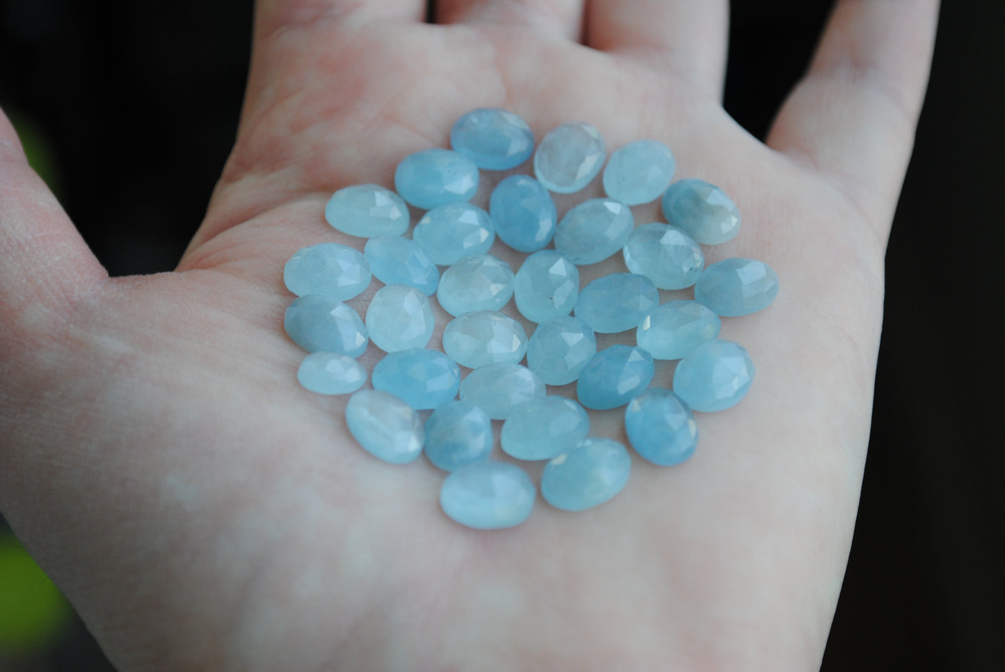 Aquamarine rose cut cabochons on palm of hand