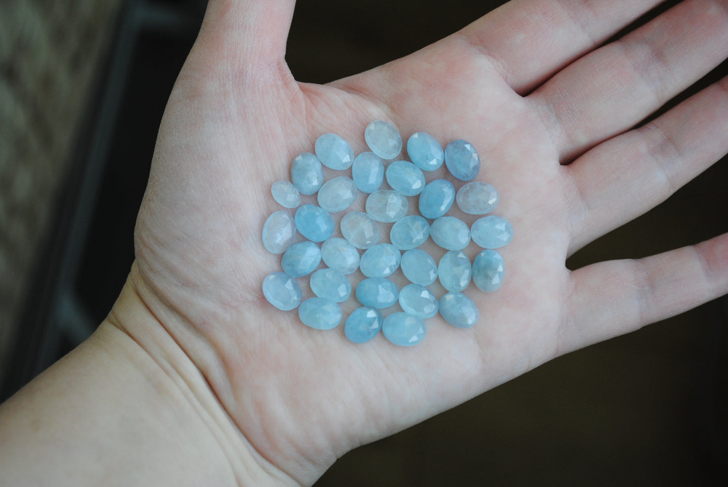 Aquamarine rose cut cabochons on palm of hand