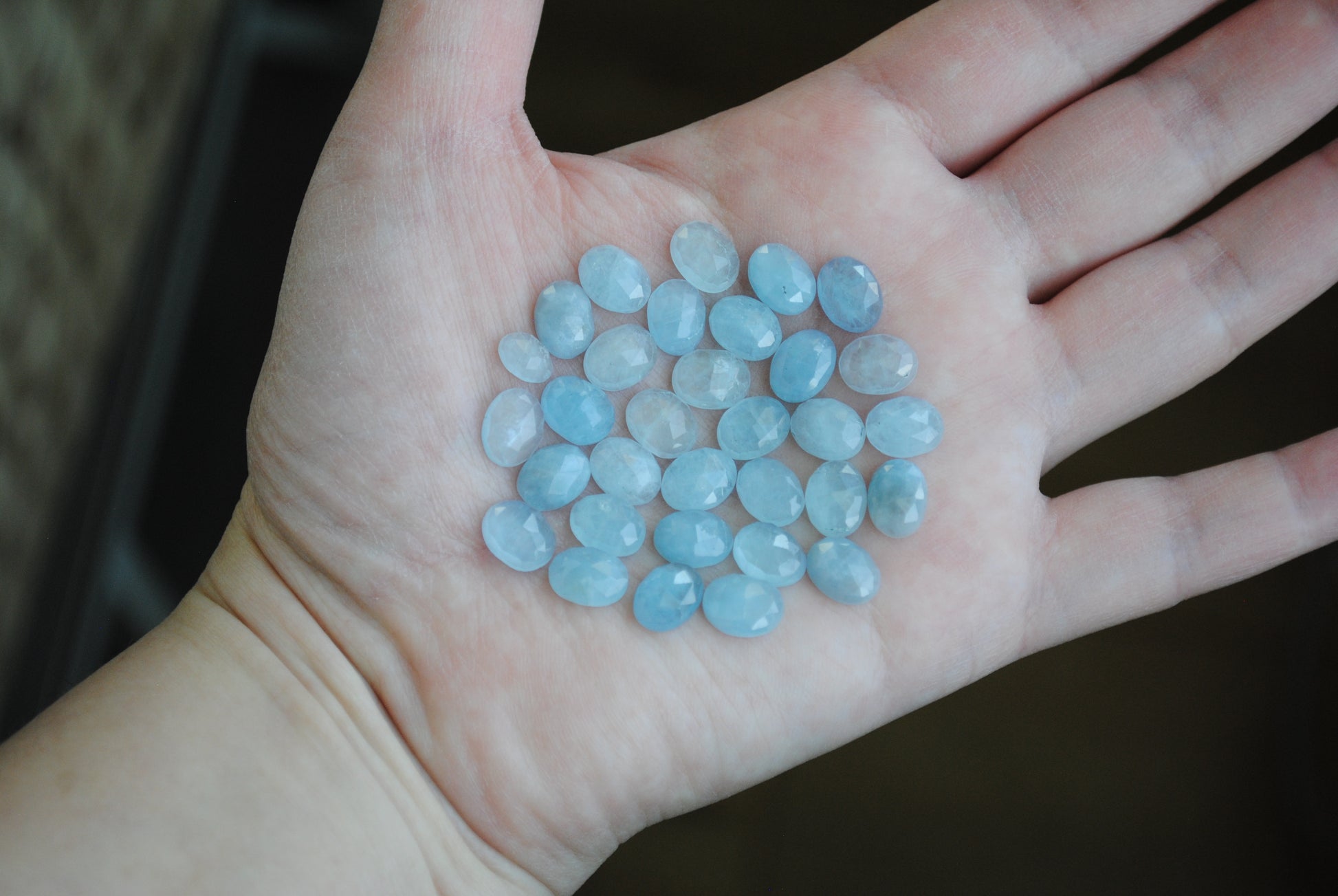 Aquamarine rose cut cabochons on palm of hand
