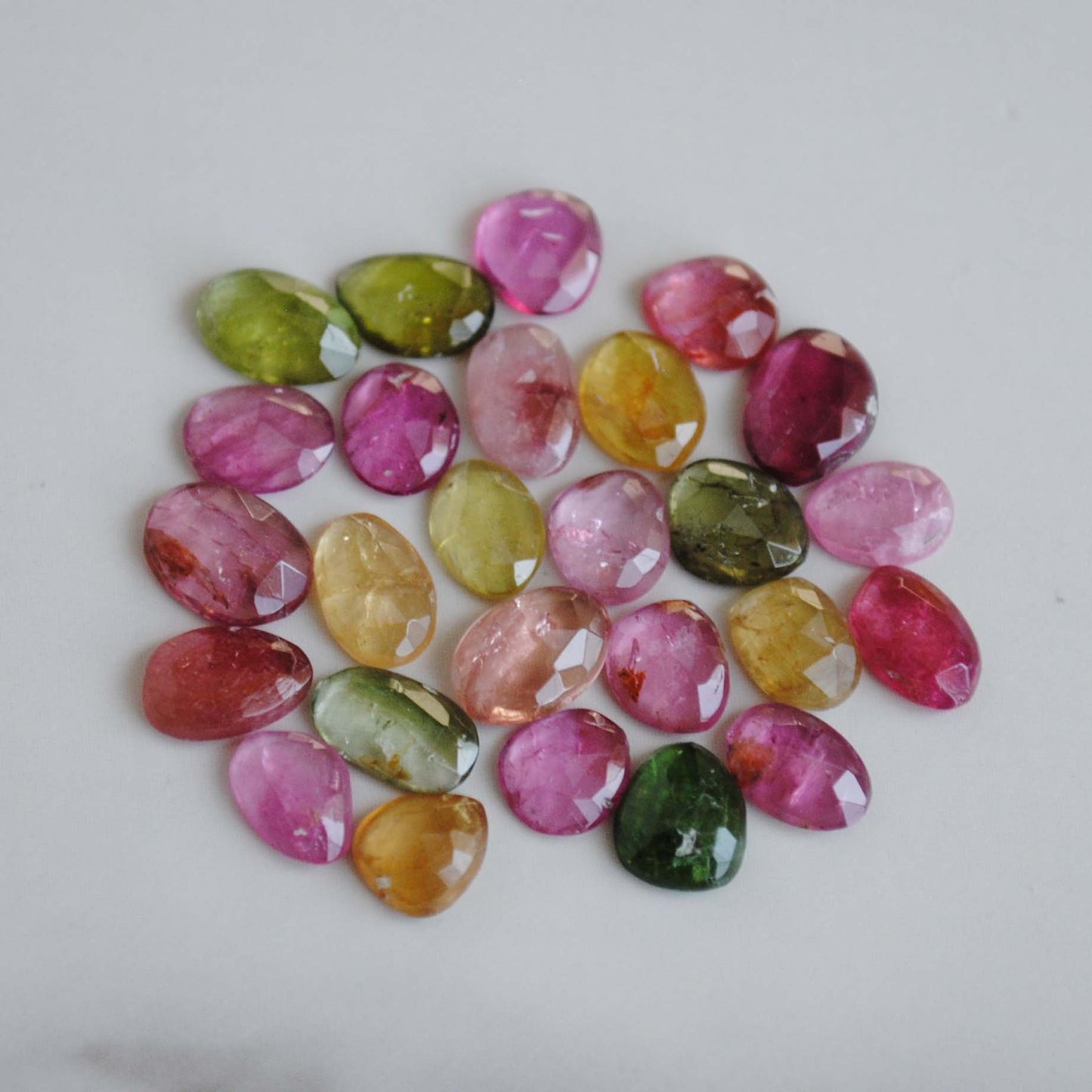 Tourmaline rose cut cabochons on light background