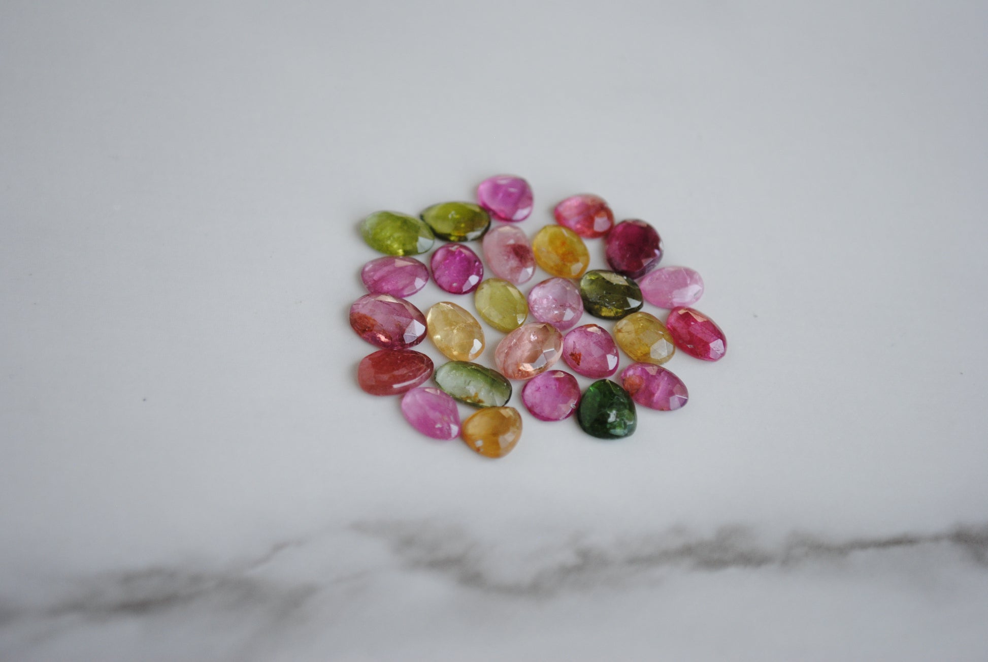 Tourmaline rose cut cabochons on light background