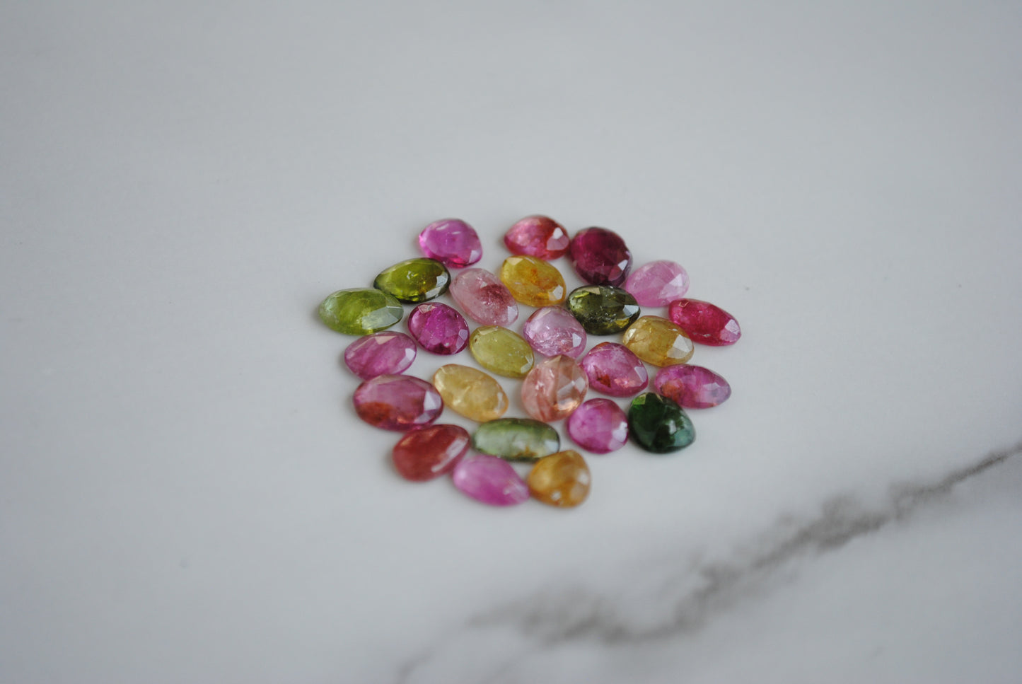 Tourmaline rose cut cabochons on light background